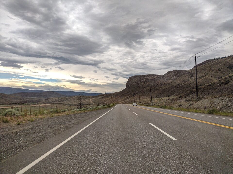 An empty road with a mountain in the background