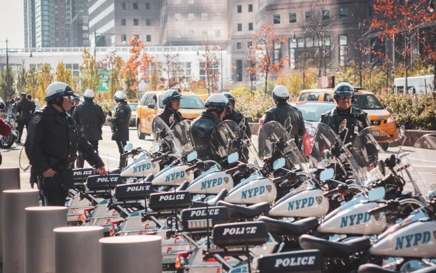 a group of police officers standing around parked motorcycles