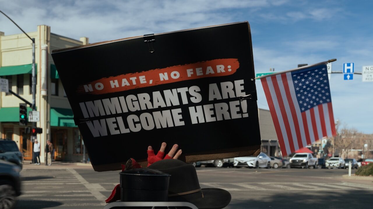 Protest sign reads immigrants are welcome here