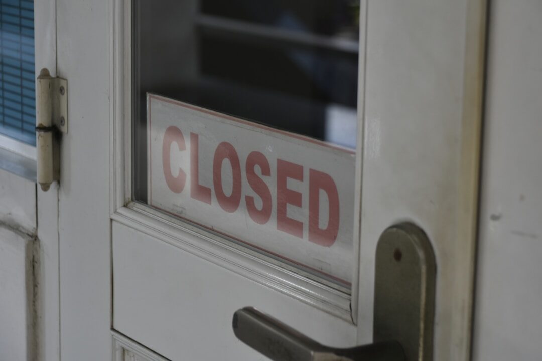 closed signage on white wooden half-glass door