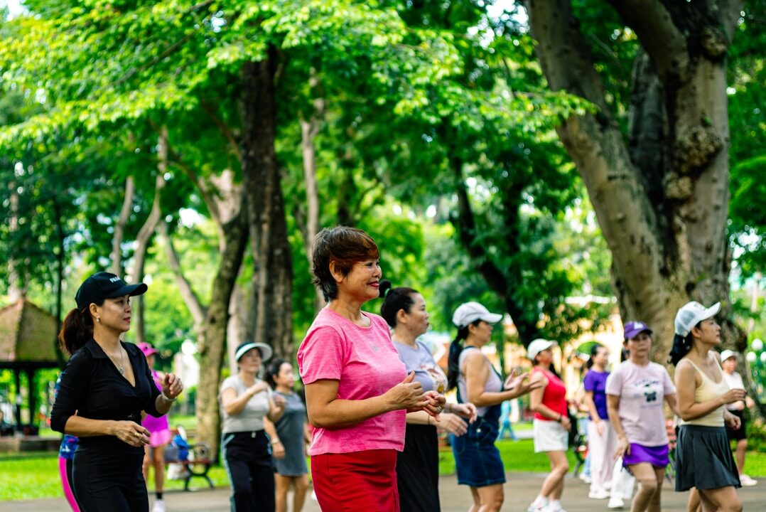 Group of women exercising in a park.